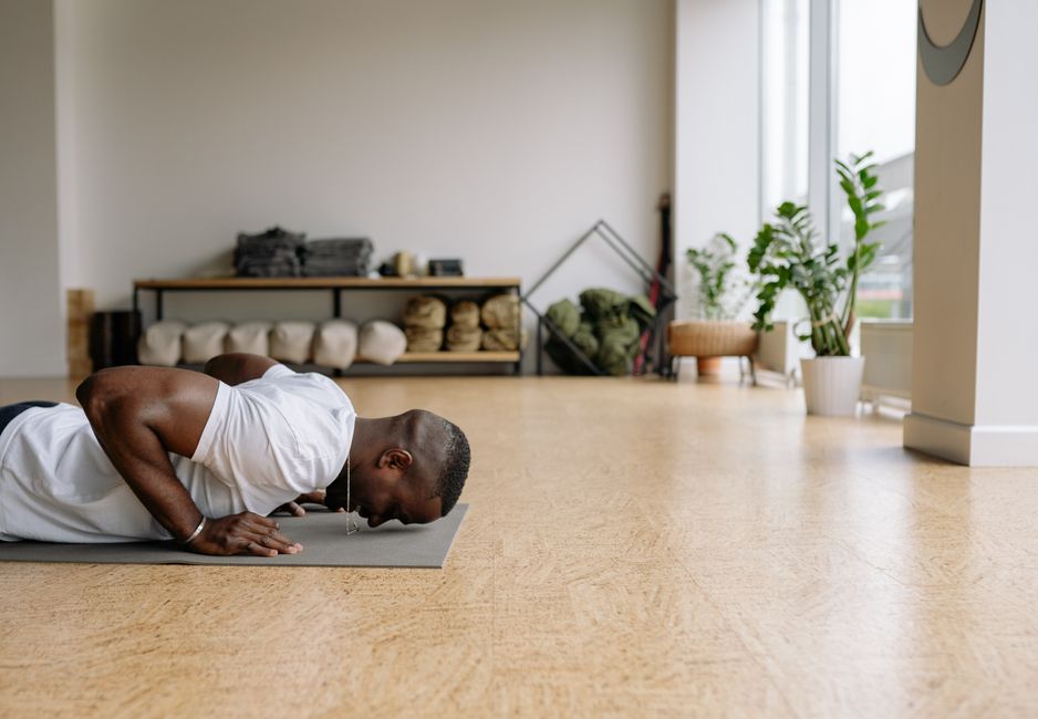 Empty yoga studio floor lit by soft natural light